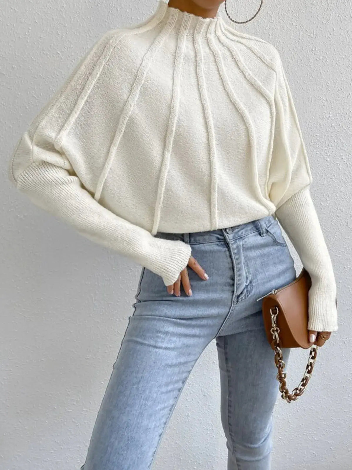 Soft ribbed mock-neck long-sleeve sweater in cream knit.