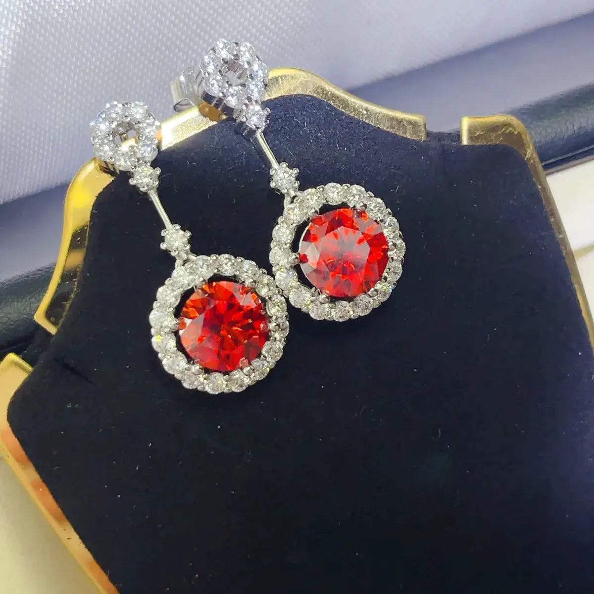 Ruby red crystal drop earrings with rhinestone halo in silver-tone setting, pair.