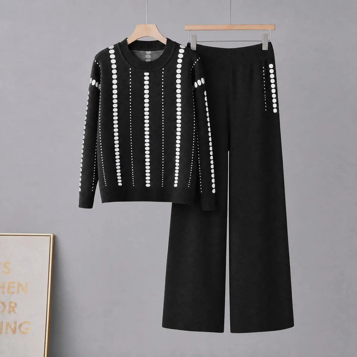 Two-piece women's black knit set with white dotted stripes; sweater and wide-leg pants, relaxed fit
