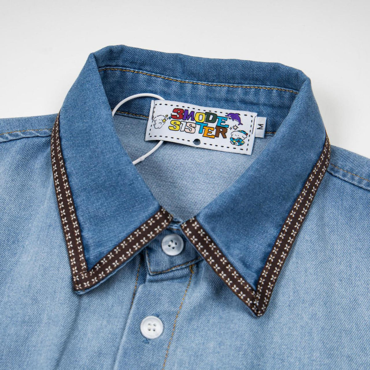 Cat embroidered denim short-sleeve shirt with light blue wash and brown floral-trim collar