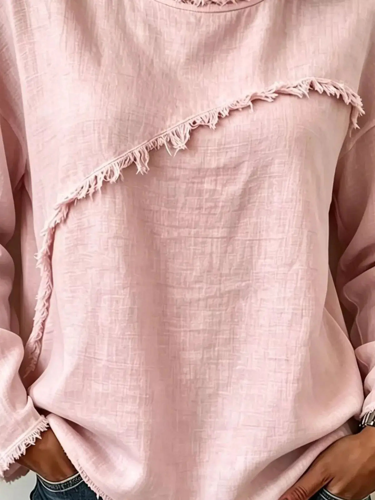 Frayed-hem pink dropped-shoulder blouse with diagonal fringe trim and soft textured fabric