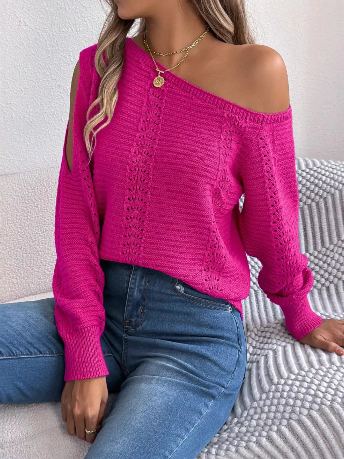 Openwork magenta one-shoulder cutout knit sweater with long sleeves.