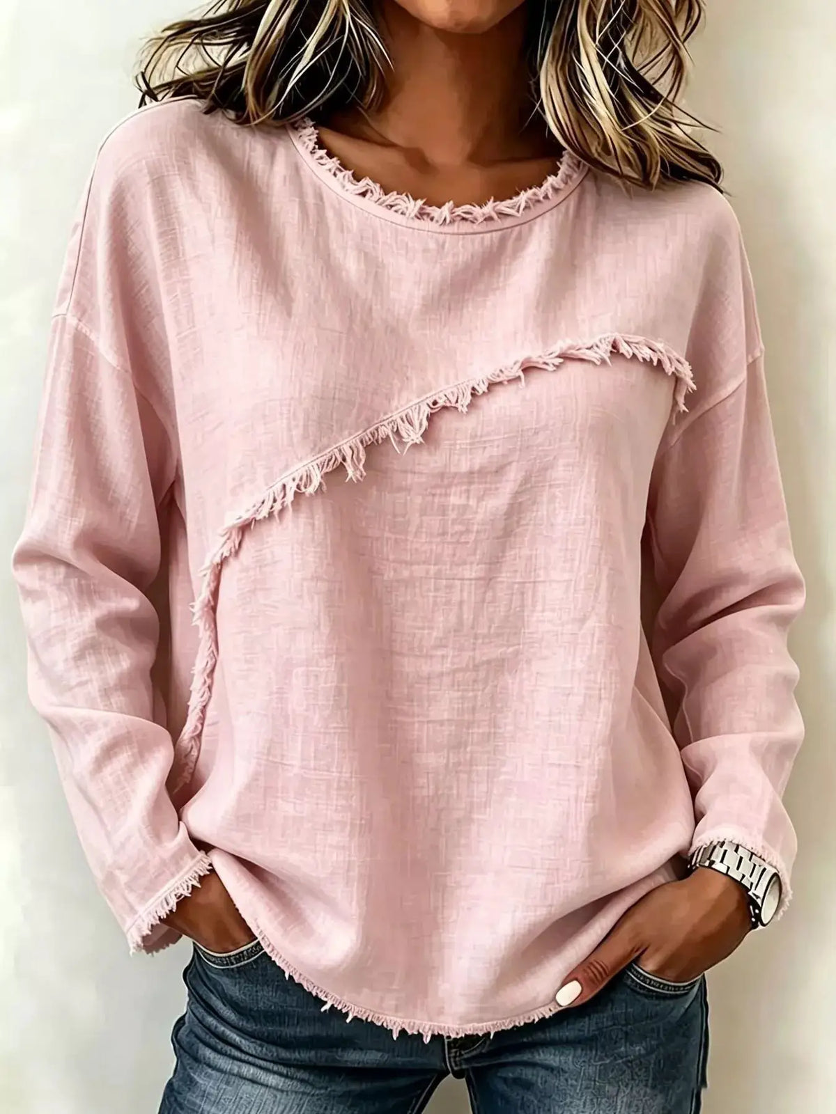 Frayed-hem dropped-shoulder blouse in pale pink with diagonal fringe trim