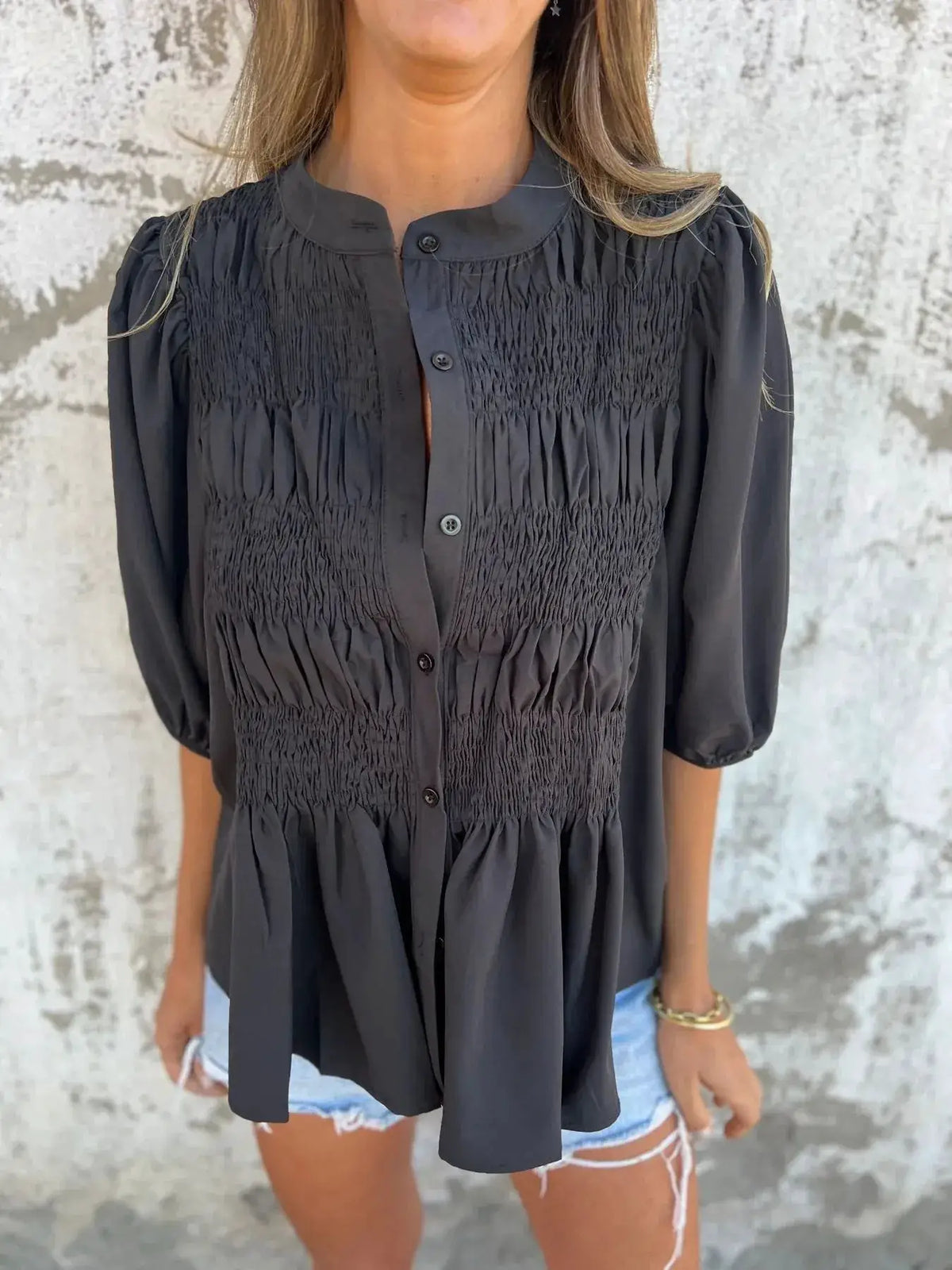 Plus-size smocked puff-sleeve blouse in black; button-front with shirred panels.