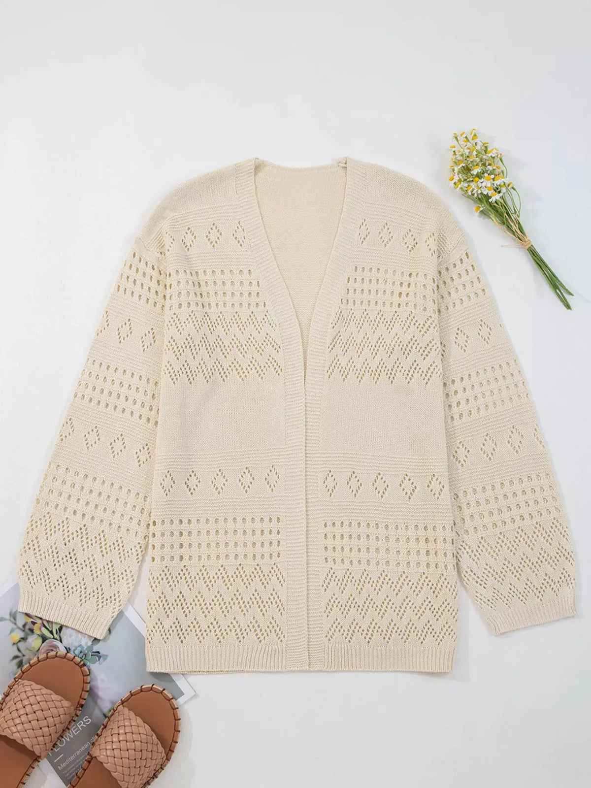 Hollowed knit open-front cardigan in cream with geometric eyelet pattern and side pockets