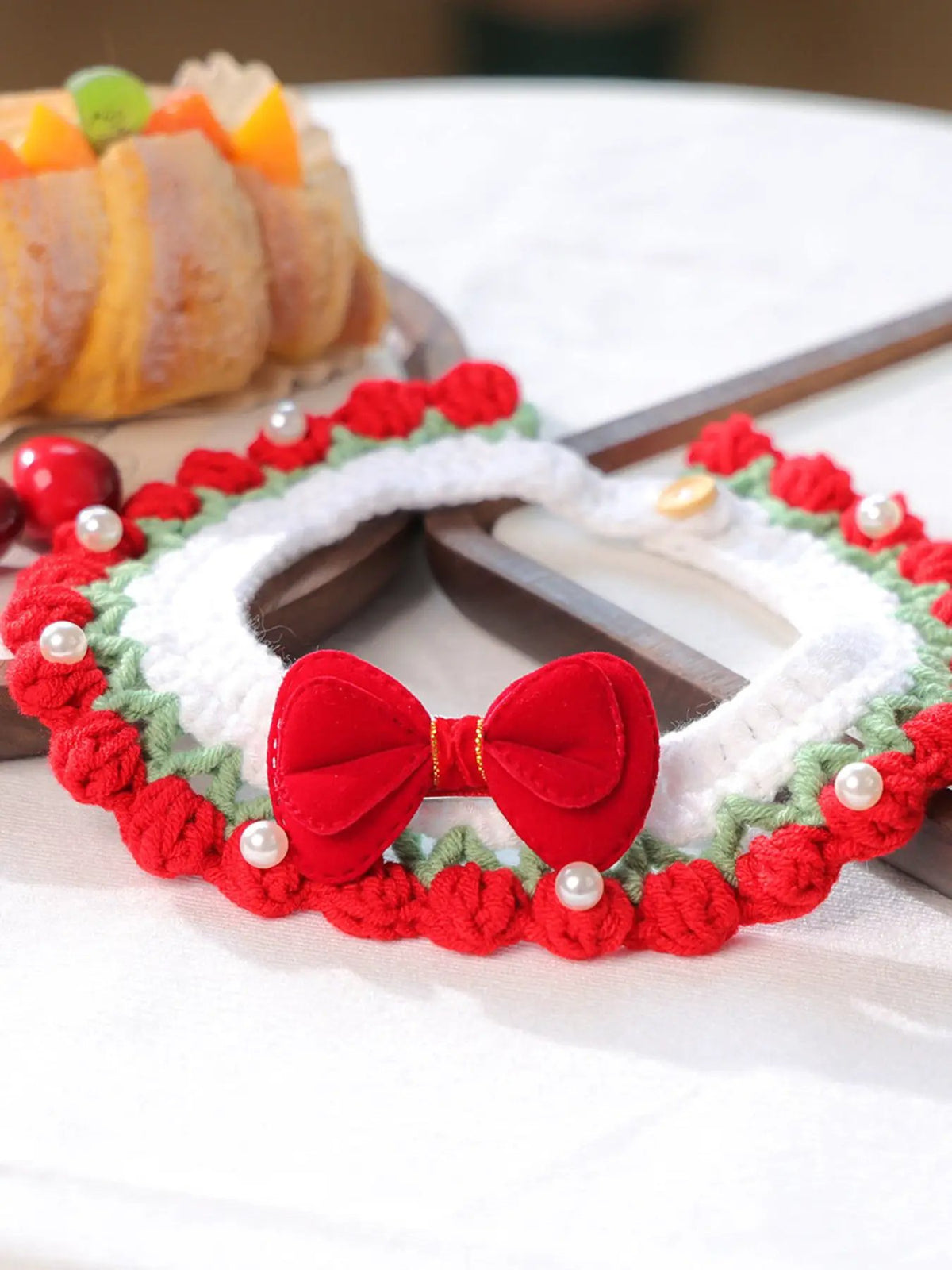 Contrast Pet Scarf: circular crochet loop in red and white with a red bow and pearl accents