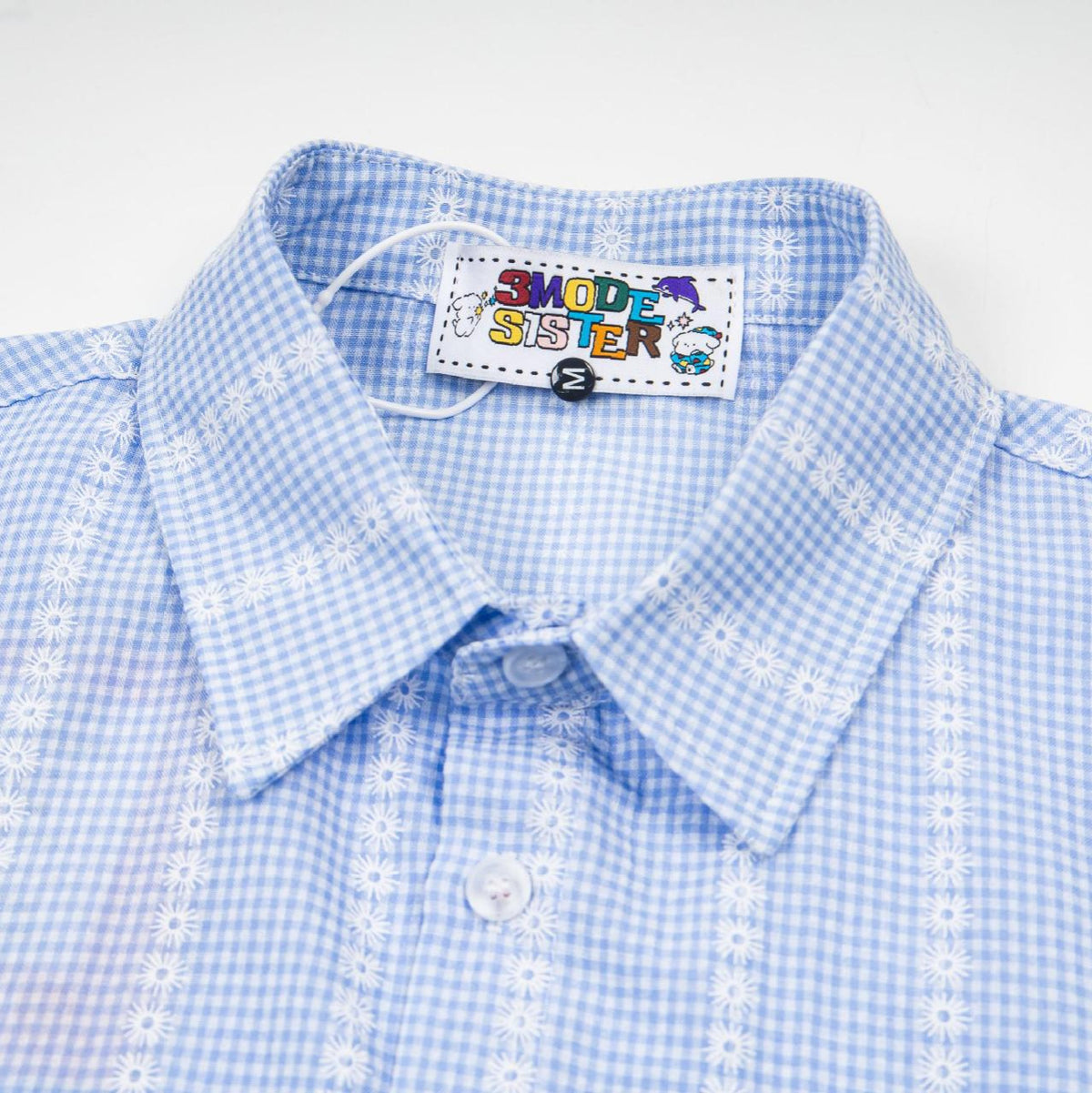 Flower graffiti checkered short-sleeve shirt, light blue gingham with white daisy embroidery, by eprolo.
