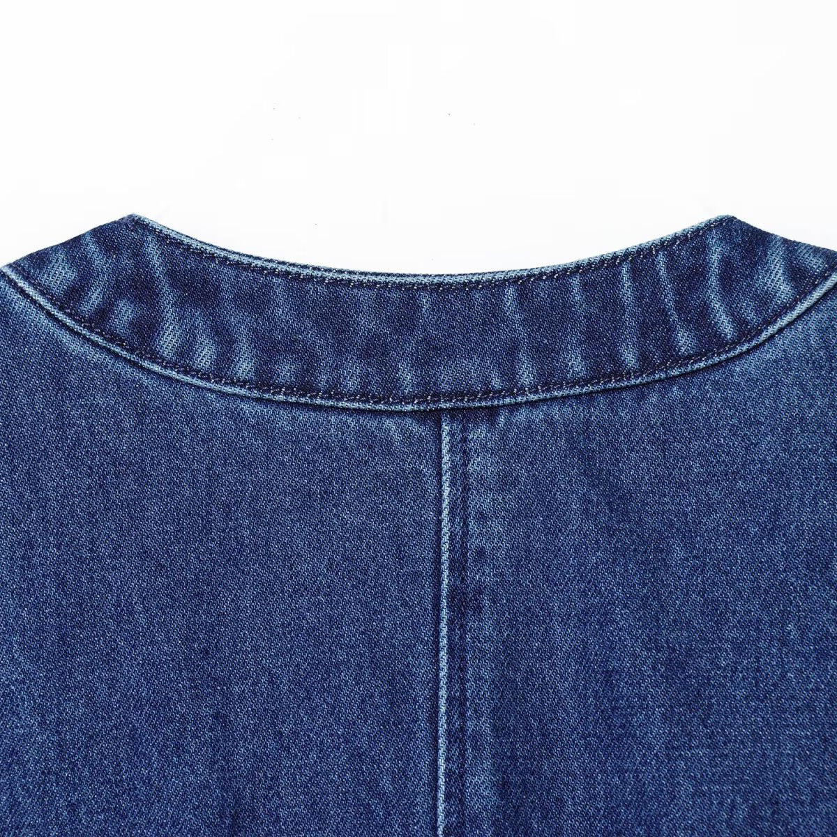 Nail drill denim vest back neckline close-up; indigo blue denim with visible stitching, by eprolo