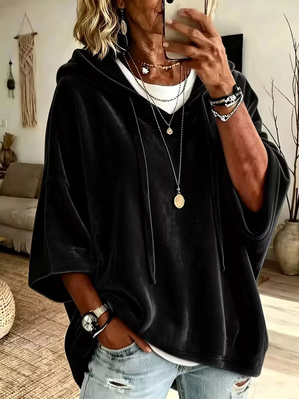 Velvet loose-fit hoodie with drawstring in black; oversized casual top.