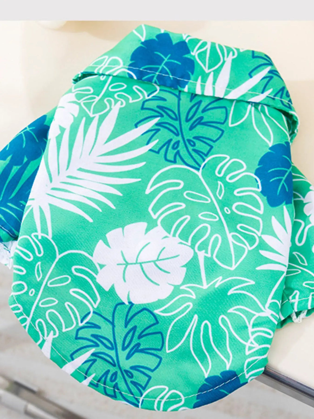 Lightweight pet top by Trendsi; tropical teal print with white/blue palm leaves.