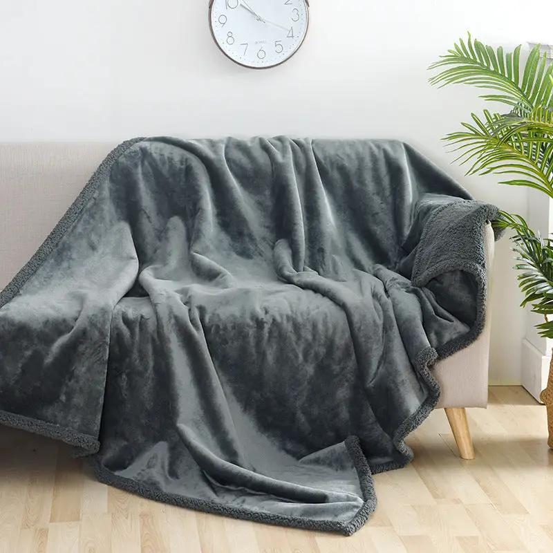 Waterproof blanket in gray flannel cotton velvet, draped over a sofa.