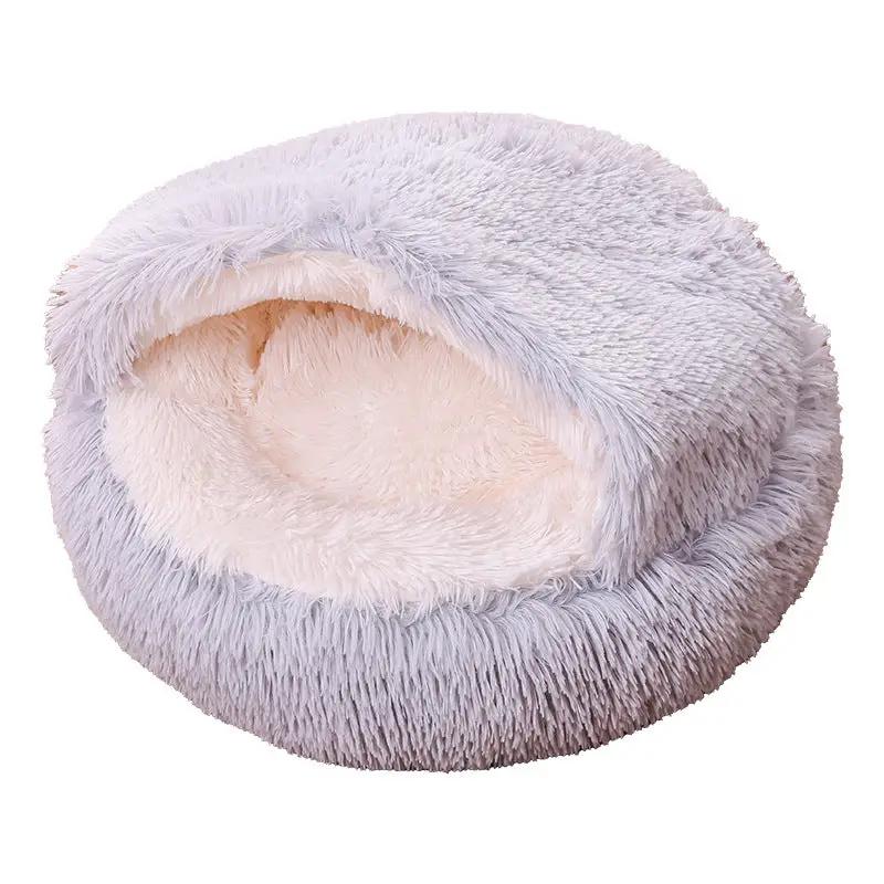 Pet bed, round donut-style, plush gray exterior with beige inner lining.