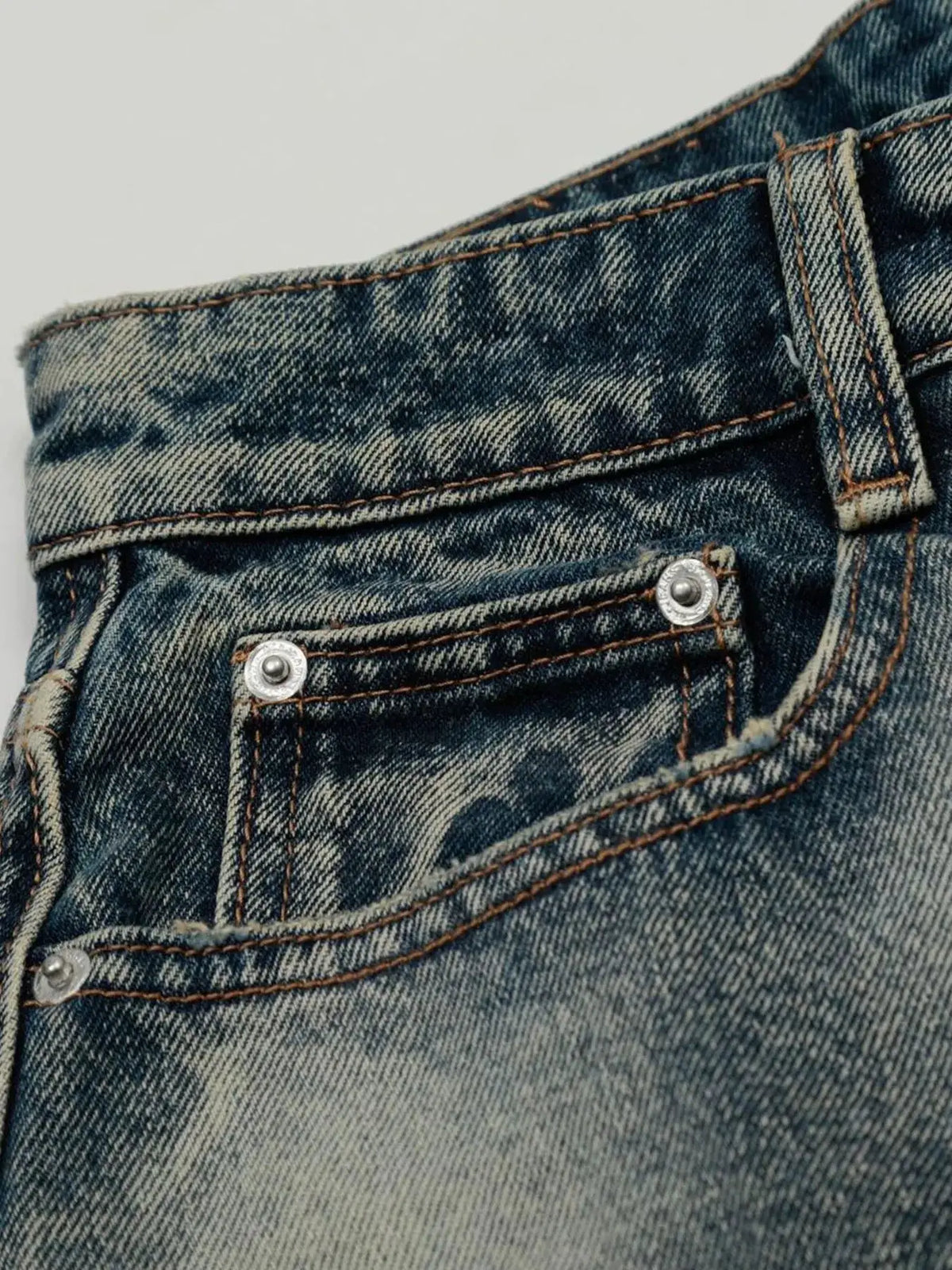 Men's acid-wash denim shorts with stretch cotton blend, close-up of blue denim fabric and stitching
