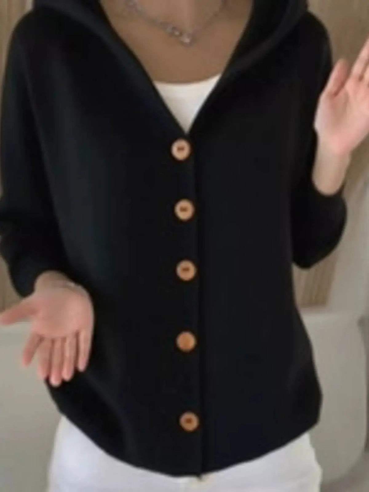 Plus Size Hooded Button Front Soft Knit Cardigan for Women in black with tan wooden buttons by Trendsi.