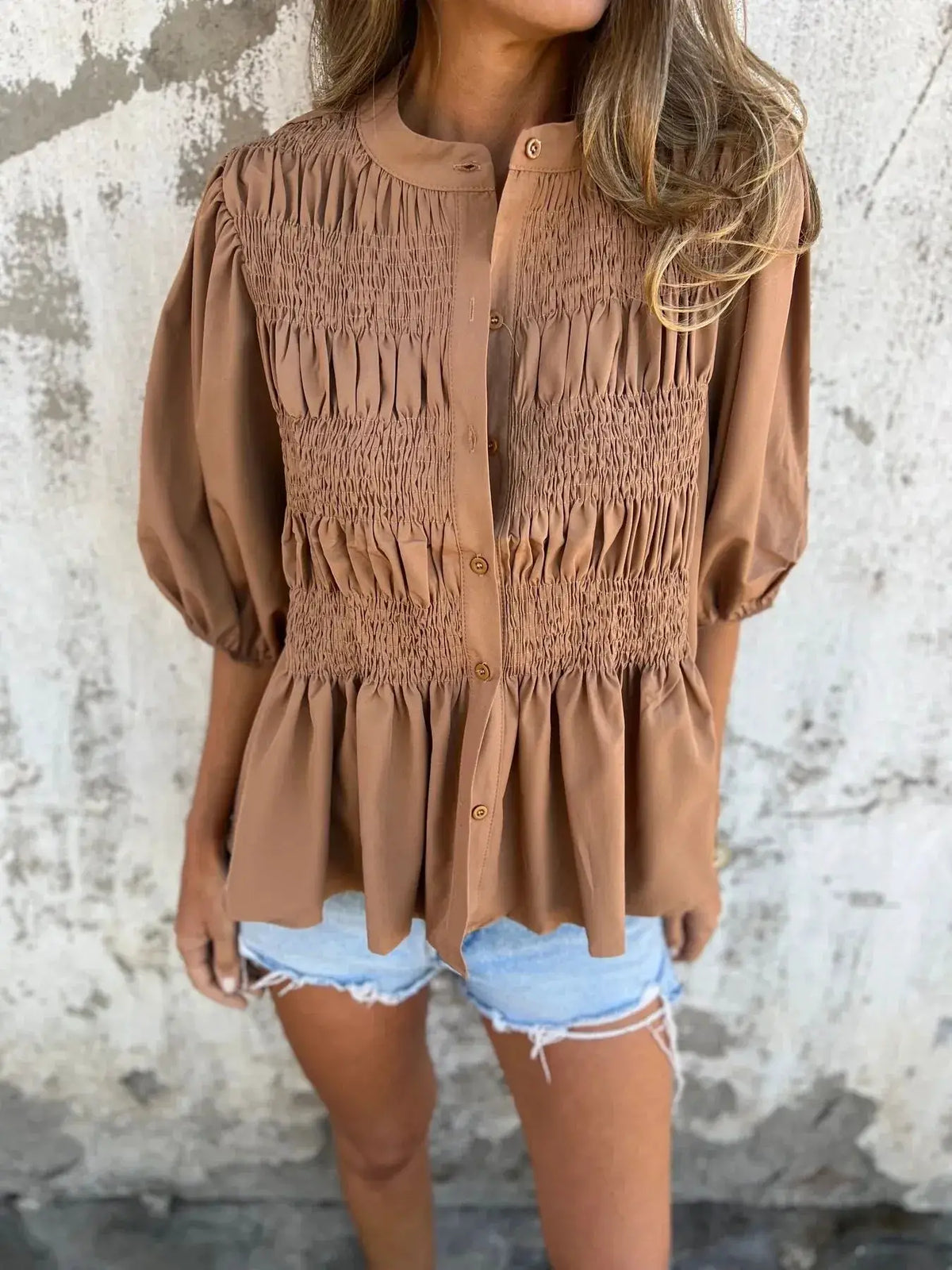 Plus-size smocked puff-sleeve blouse in tan with shirred front panels and button placket.