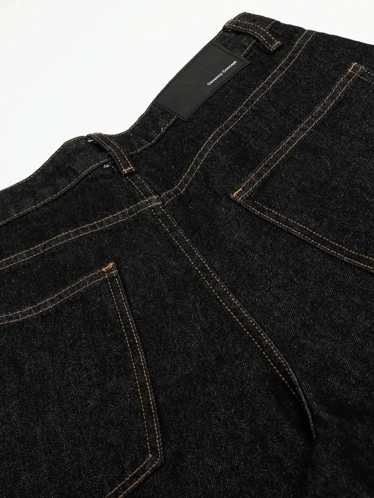 Men's relaxed baggy denim shorts in dark indigo with orange contrast stitching and back pockets