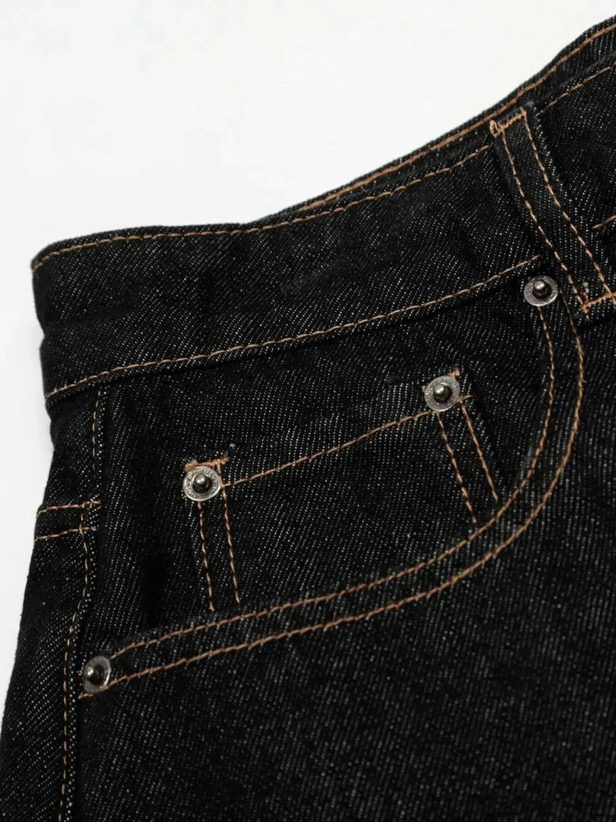 Men's dark indigo denim shorts with orange contrast stitching and metal rivets