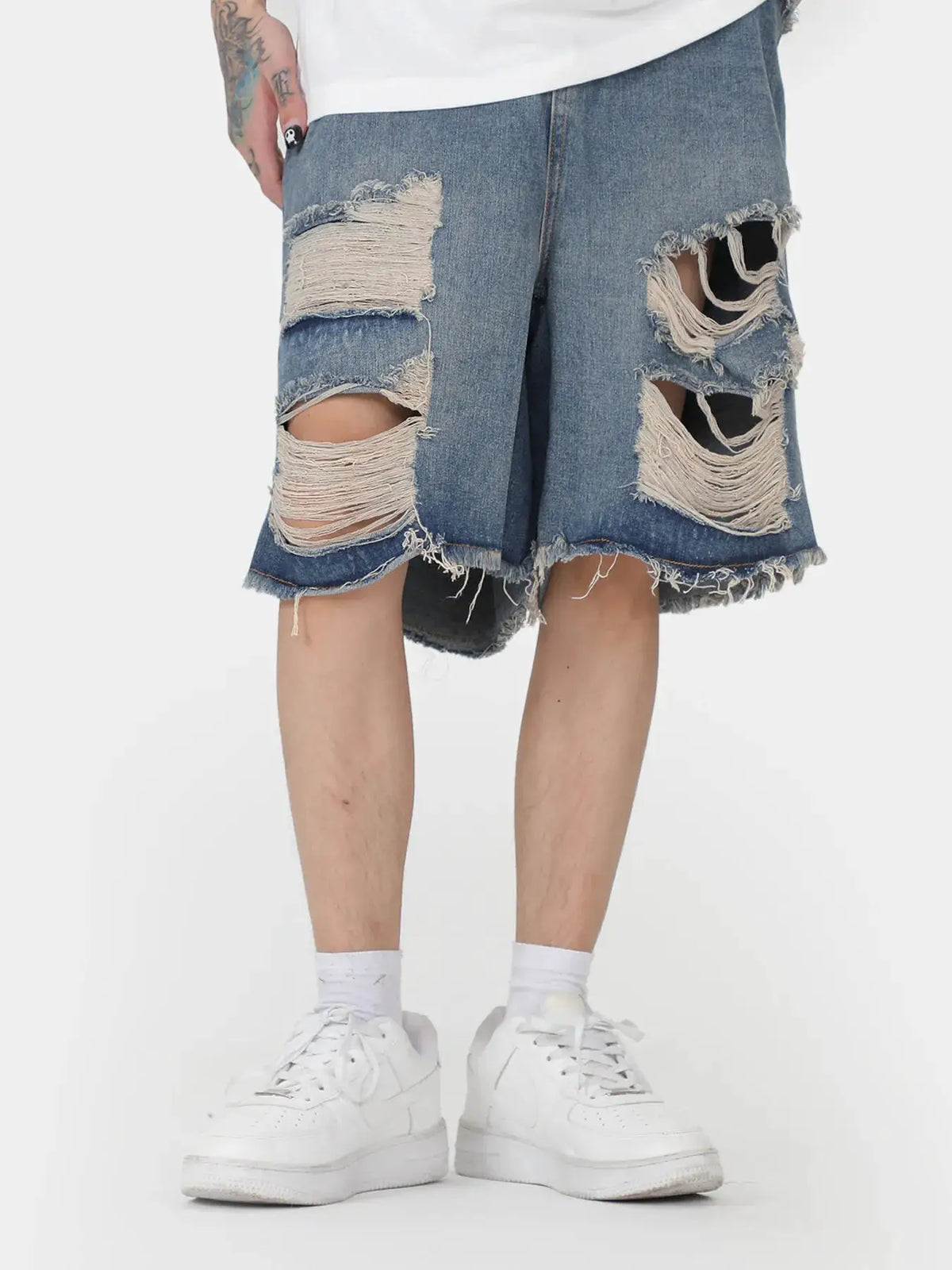Mens oversized distressed denim shorts with stretch cotton pockets, blue denim with large ripped patches