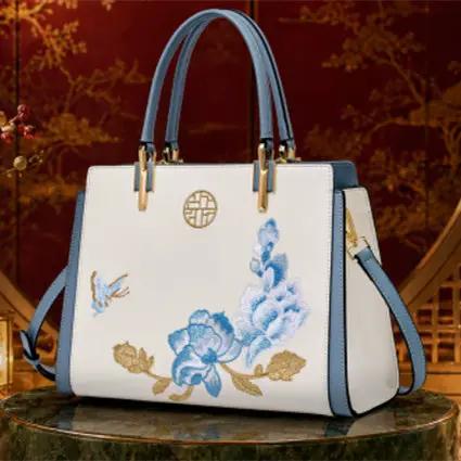 AdTec handbag tote bag with white body, blue floral embroidery and blue trim