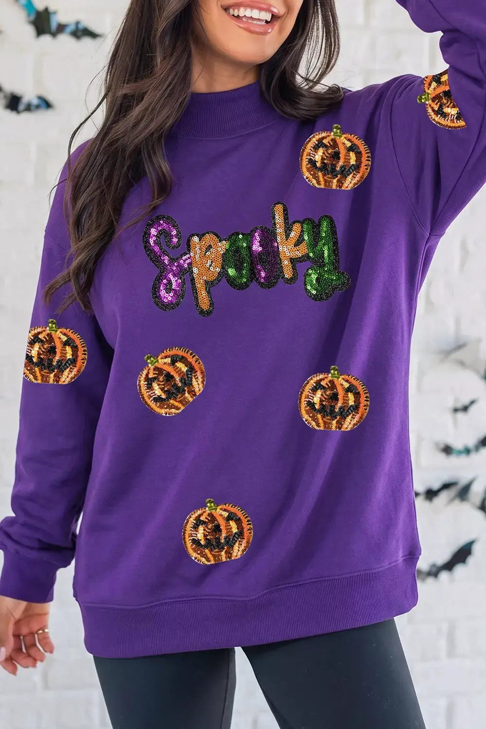 Sequin Pumpkin Spooky Halloween Sweatshirt, purple with multicolored sequined pumpkins and Spooky lettering.