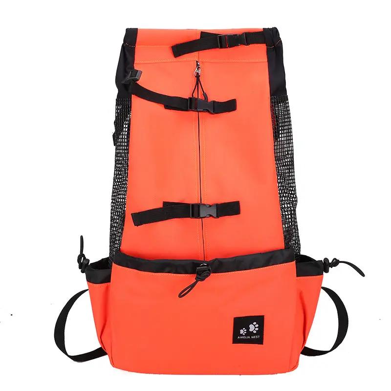 Dog carrier backpack in bright orange with black straps and mesh side panels for travel