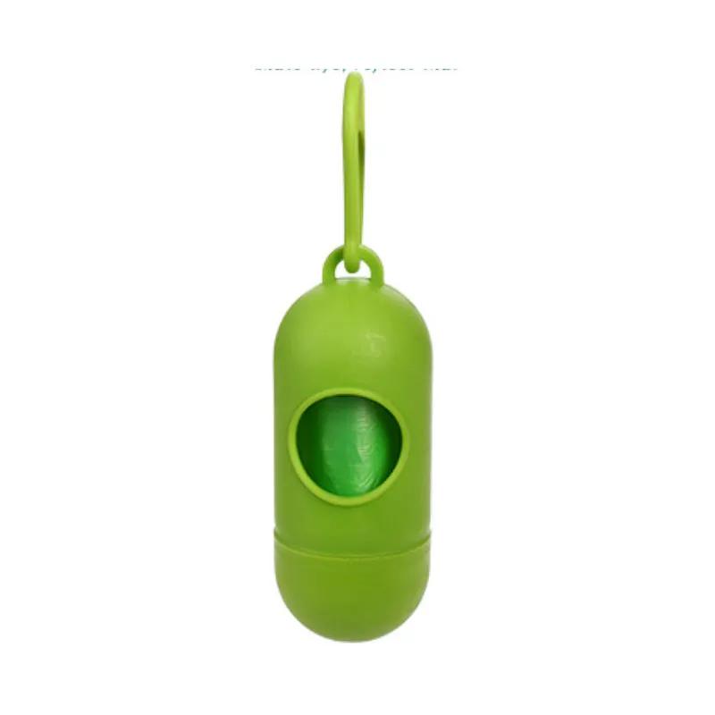 Green dog poop bag dispenser with visible bag roll and hanging loop