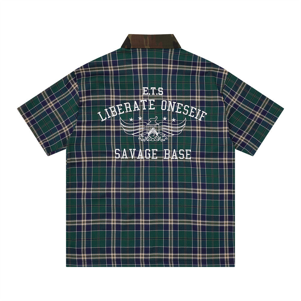 Loose plaid short-sleeve shirt in green and navy with large white back embroidery reading LIBERATE ONESELF SAVAGE BASE