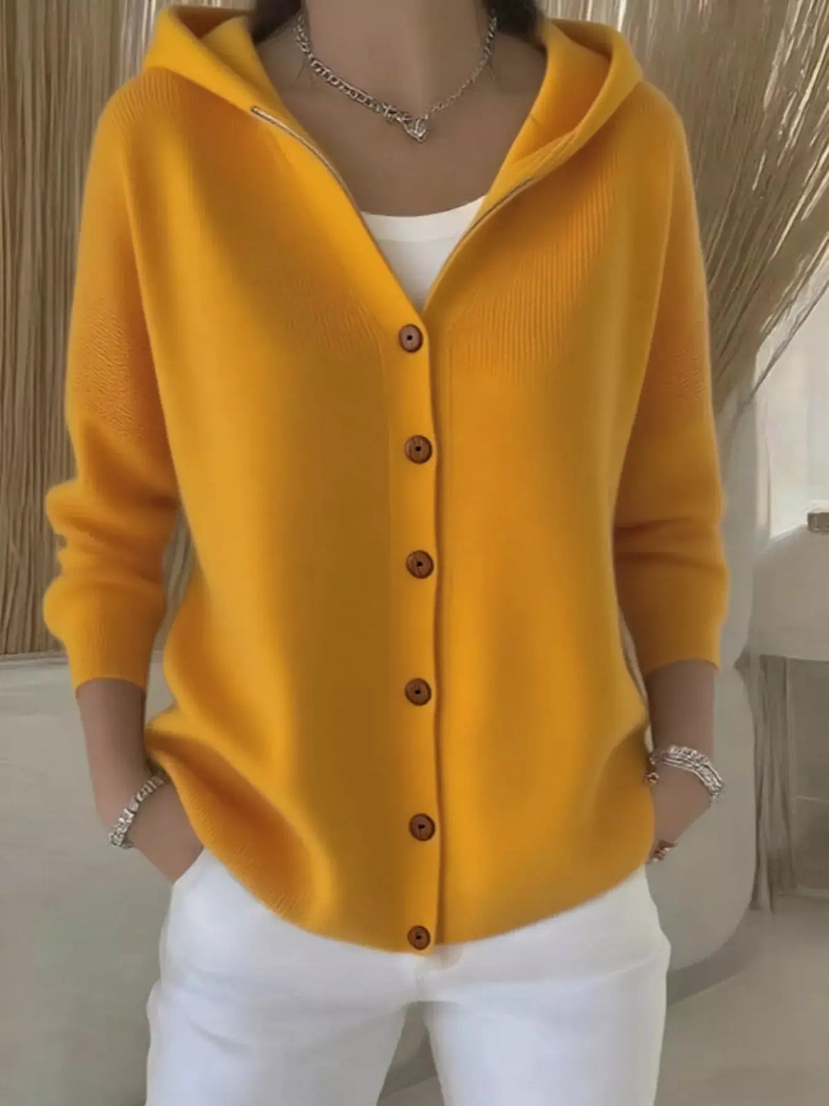 Plus-size hooded button-front soft knit cardigan in mustard yellow with brown buttons.