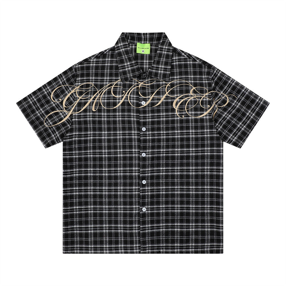 Loose short-sleeved checkered shirt by eprolo, black and white plaid with beige script across chest.