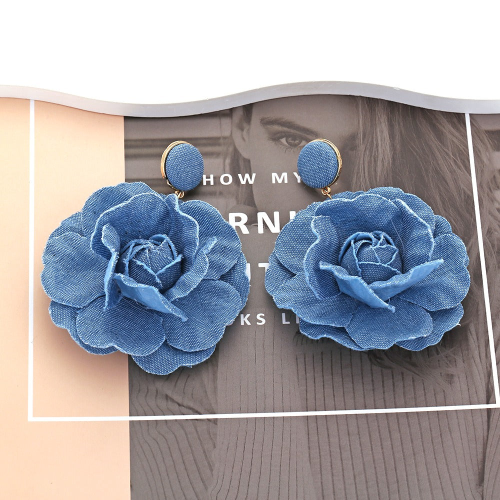 Denim flower earrings pair with blue fabric petals and round blue stud tops