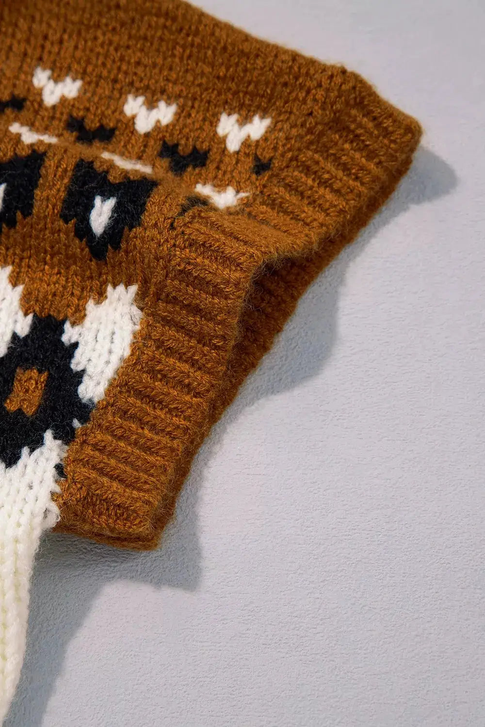 V-neck short sleeve geometric sweater in rust brown with white and black knit pattern