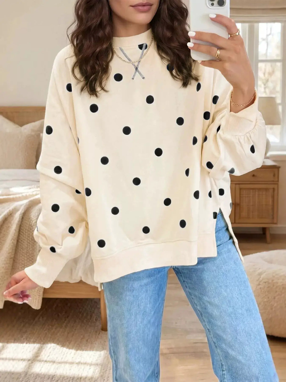 Side Slit Polka Dot Oversized Sweatshirt in cream with black dots; relaxed fit with long sleeves.
