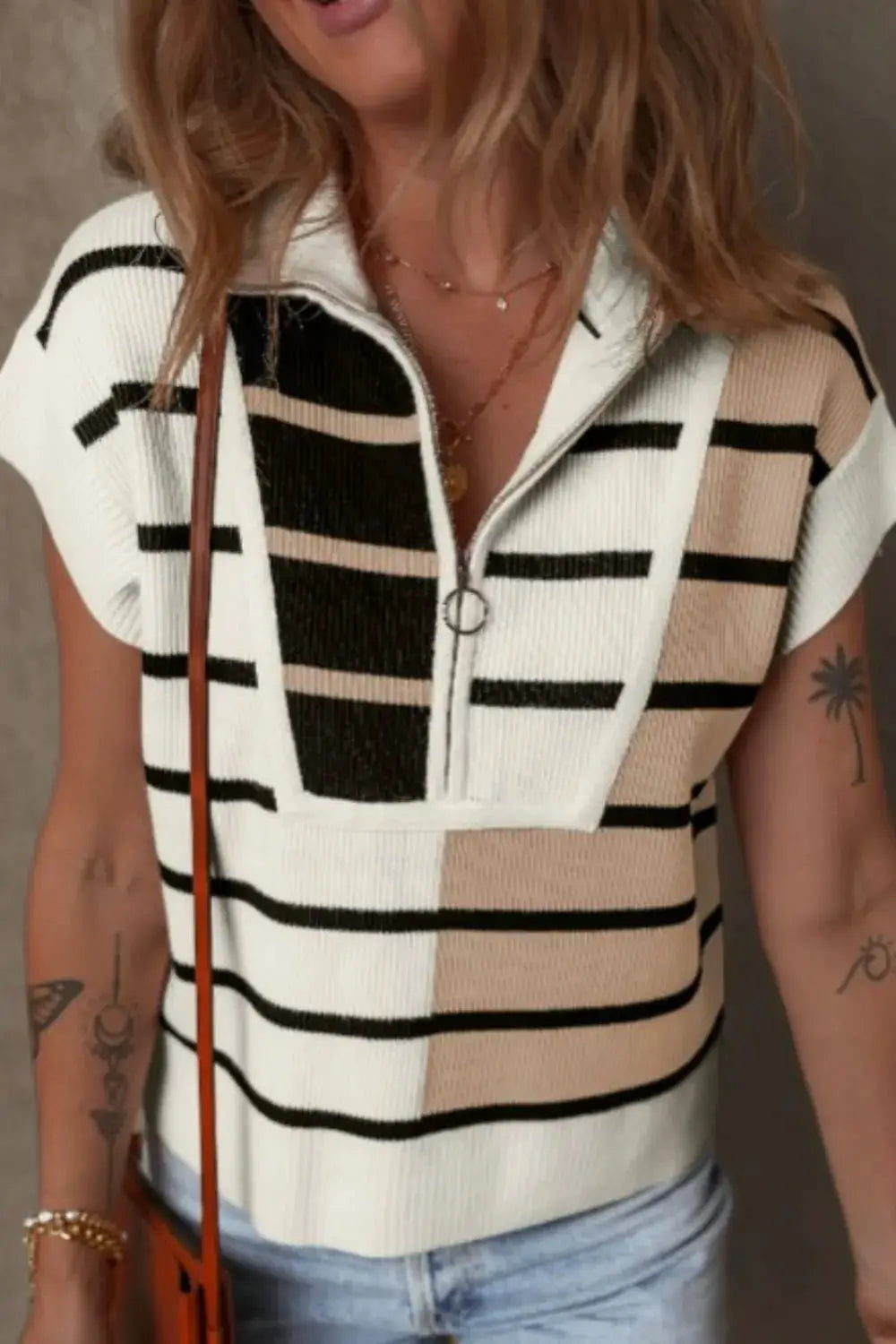 Soft stretch striped half-zip sweater vest in white, black and beige; lightweight polyester.