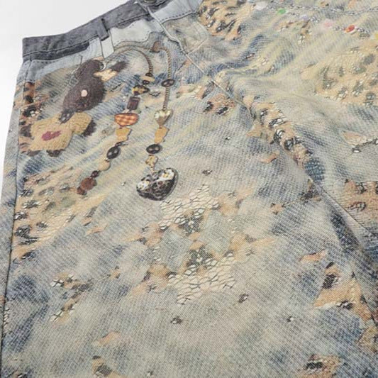 Shorts: blue washed denim cropped with printed pattern, plus pendant necklace on fabric