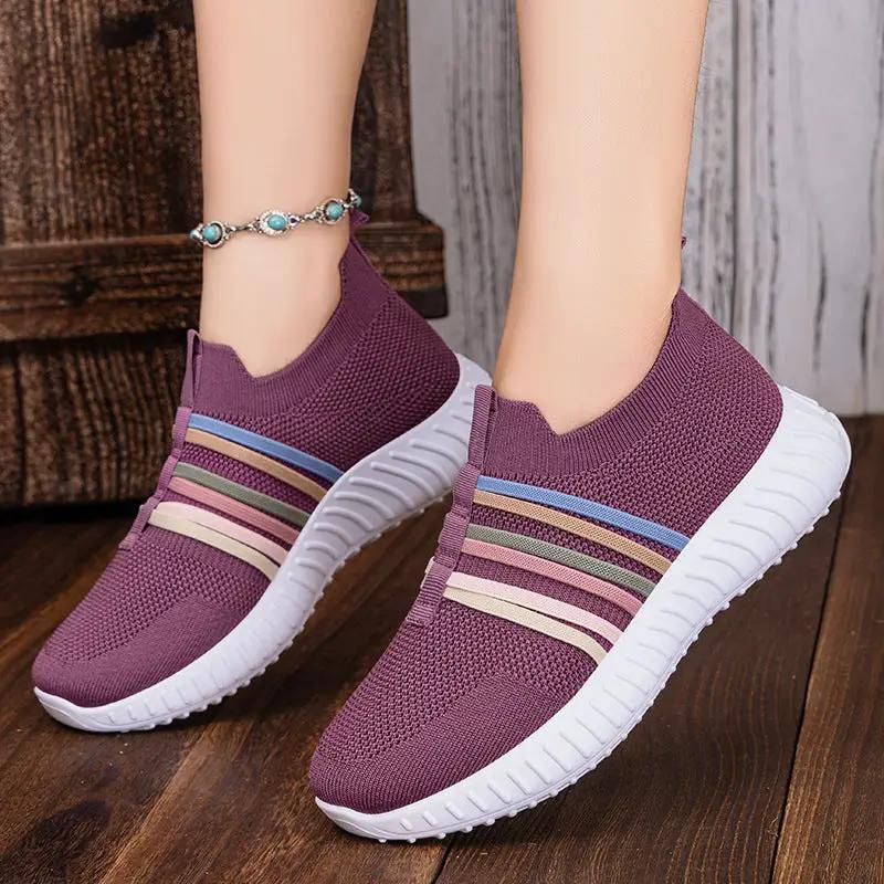 AdTec women's casual breathable mesh slip-on sneakers with white sole, purple knit and striped accents.