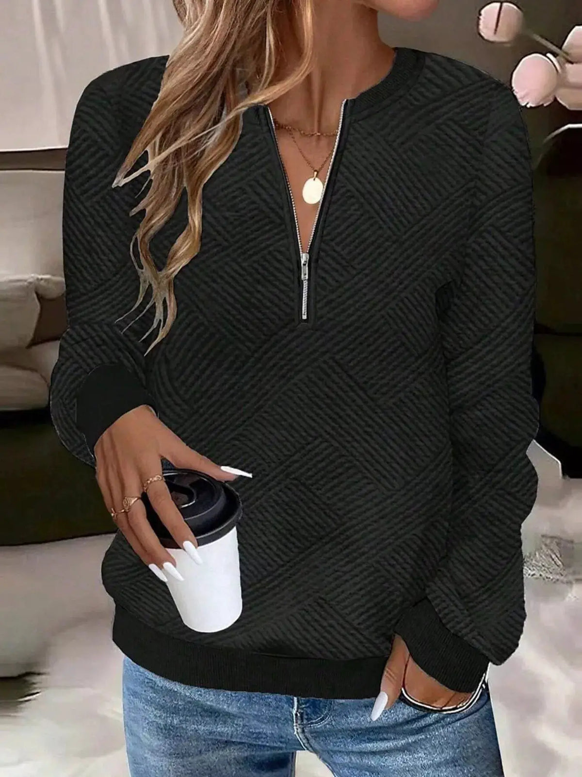 Textured Quarter-Zip Sweatshirt in black with a quilted pattern and ribbed cuffs.