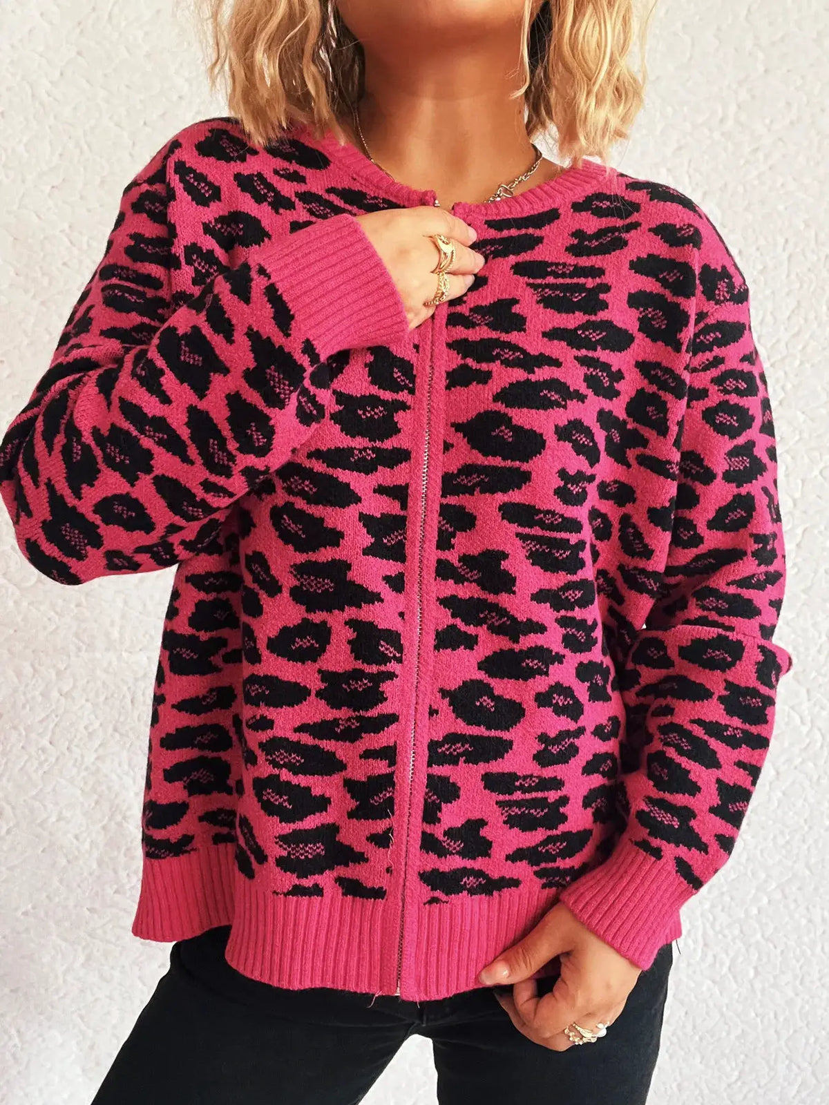 Zip-up long sleeve cardigan in bright pink with black leopard print.