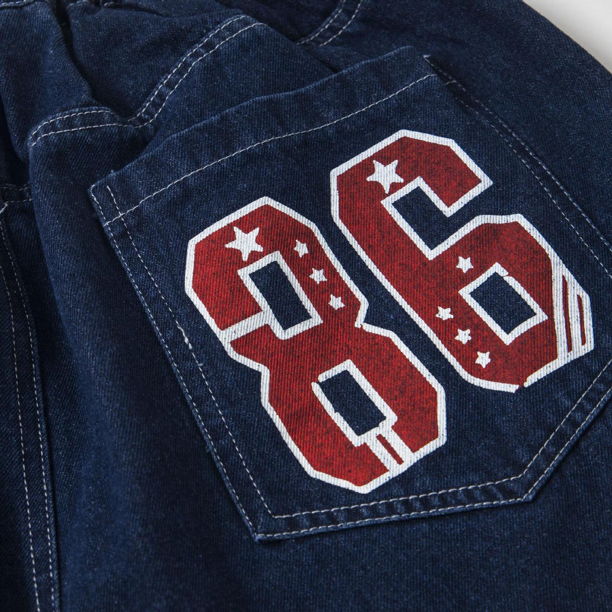 Printed loose jeans blue denim with a large red number patch on back pocket by eprolo