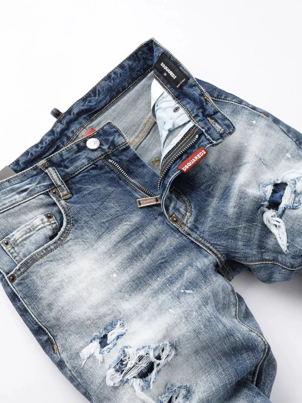 Men's distressed slim-fit jeans in blue denim with ripped knees and DSQUARED2 label.