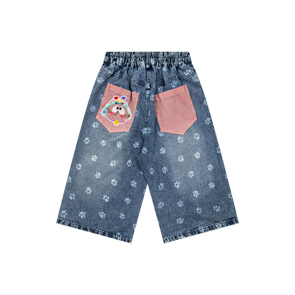 Cat cartoon denim shorts; blue denim with paw-print pattern, pink back pockets, elastic waist, by eprolo.