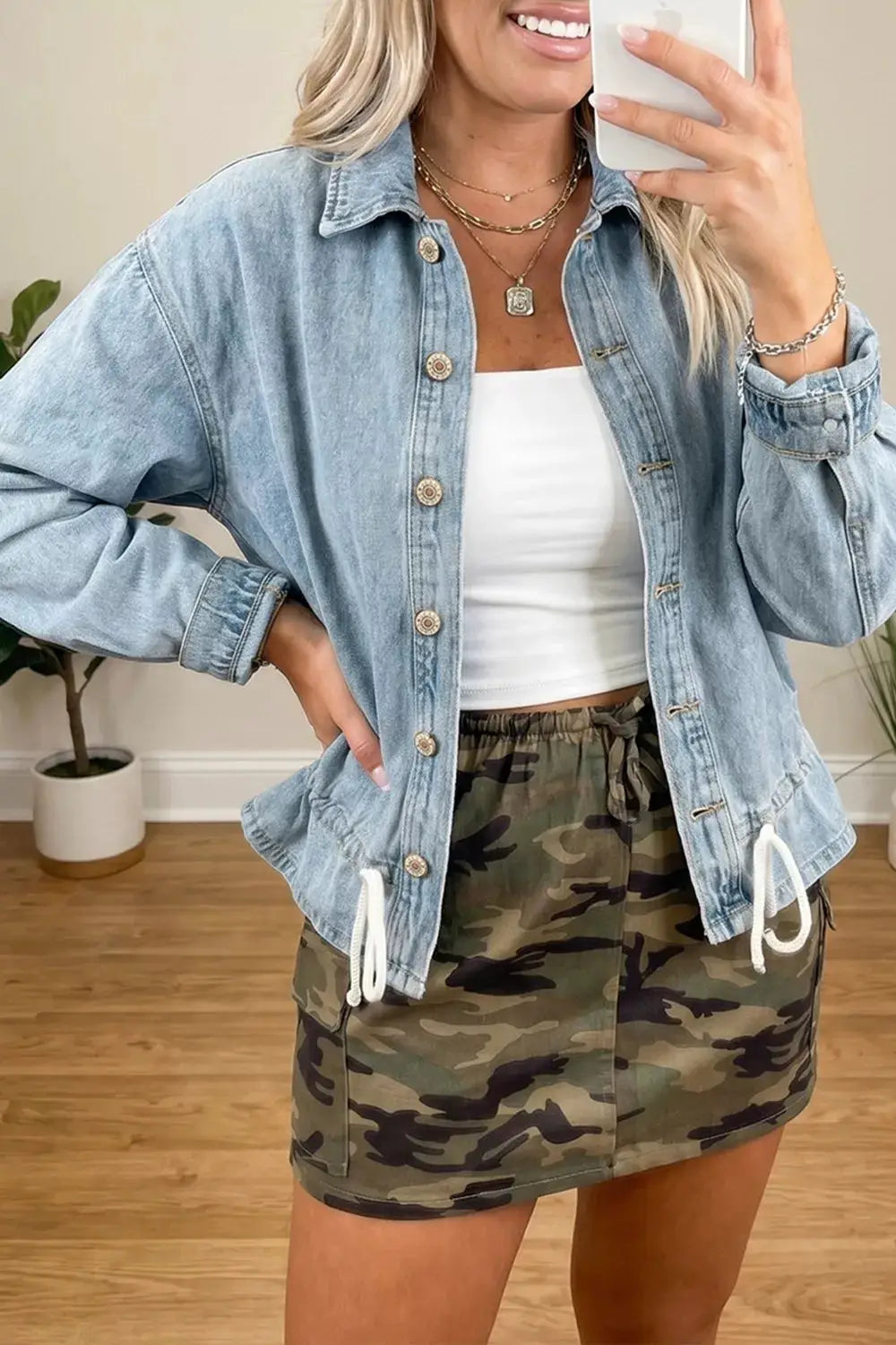 Classic light-wash denim trucker jacket by Trendsi with adjustable drawcord hem and button-front