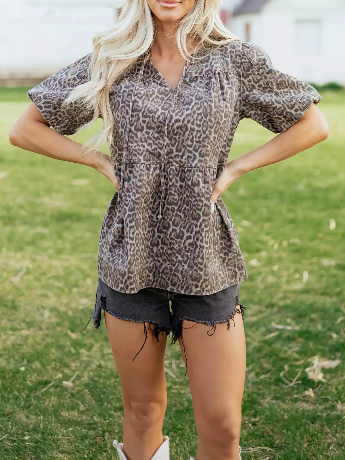 Women's leopard-print denim top with ruffle hem and puff sleeves in gray tones.