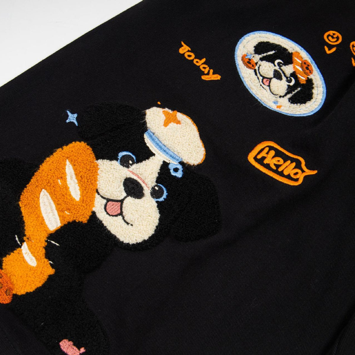 Cartoon puppy embroidered wide-leg jeans in black denim with orange/beige dog graphics by eprolo