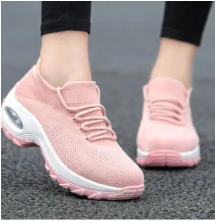 Pink knit women's athletic sneakers with white sole and cushioned air heel