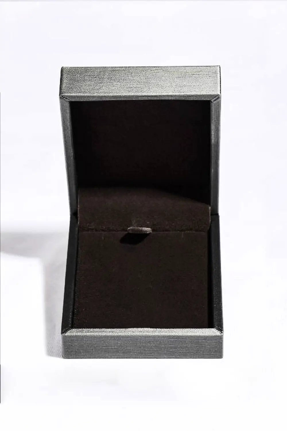Jewelry box opened, silver textured exterior with dark brown interior.