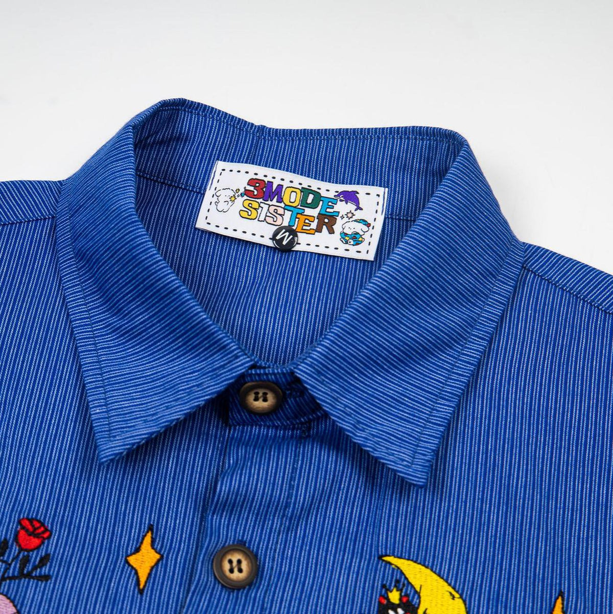 Rainbow cat embroidered short-sleeve shirt in blue pinstriped fabric, by eprolo with brown buttons