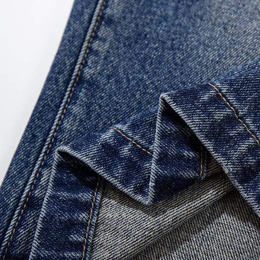 Star studded denim shorts, blue denim fabric close-up