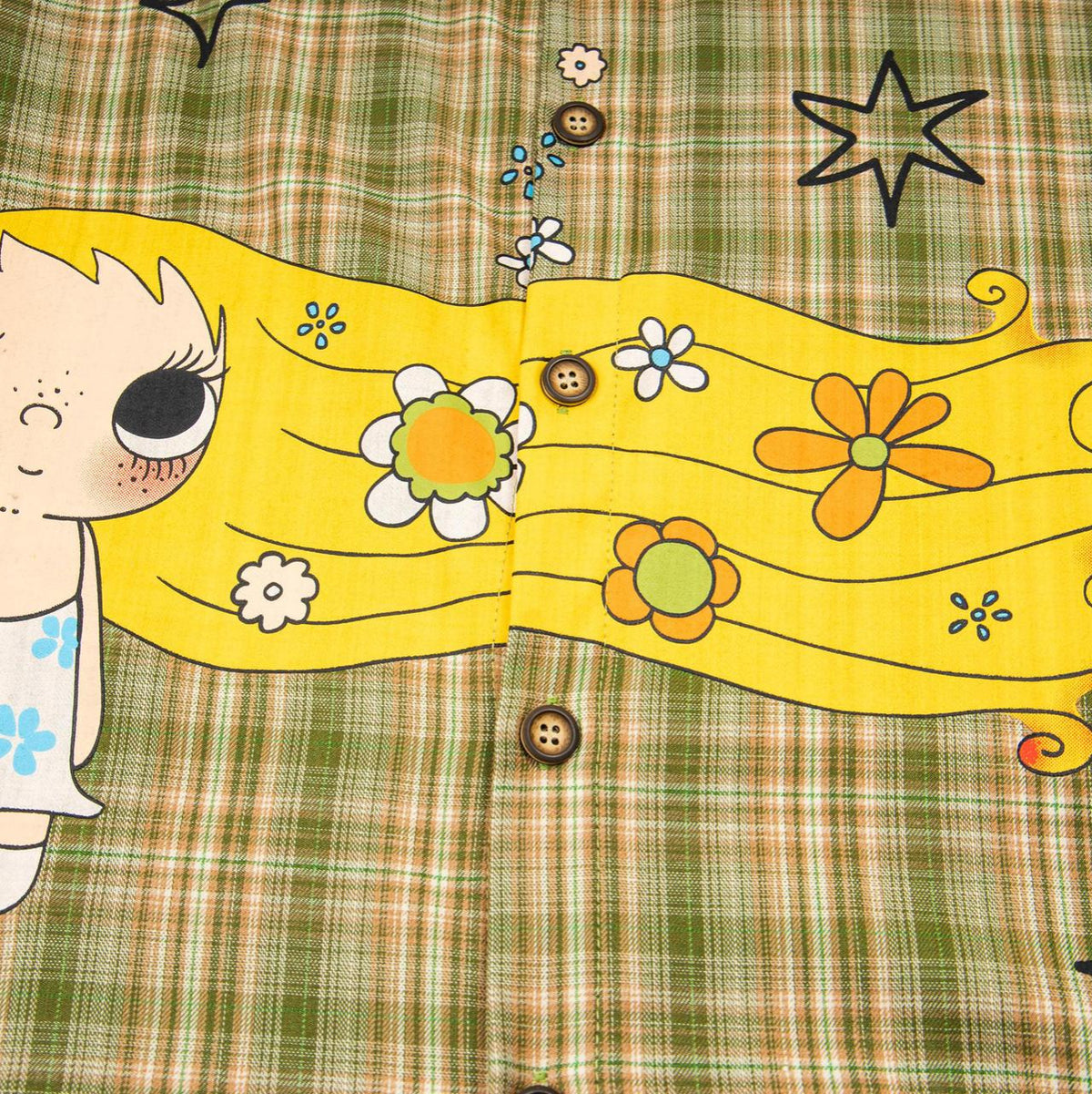 Long haired girl and puppy embroidered shirt with a bright yellow floral panel on green plaid background