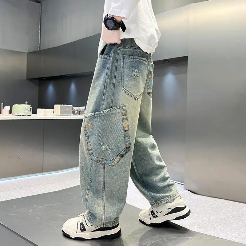 Boy's casual denim jeans in light blue, loose straight-leg fit with large side patch pocket