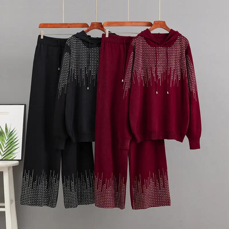 Oversized high-neck knit sweater set in black and burgundy with bead fringe; three color ensembles by eprolo.